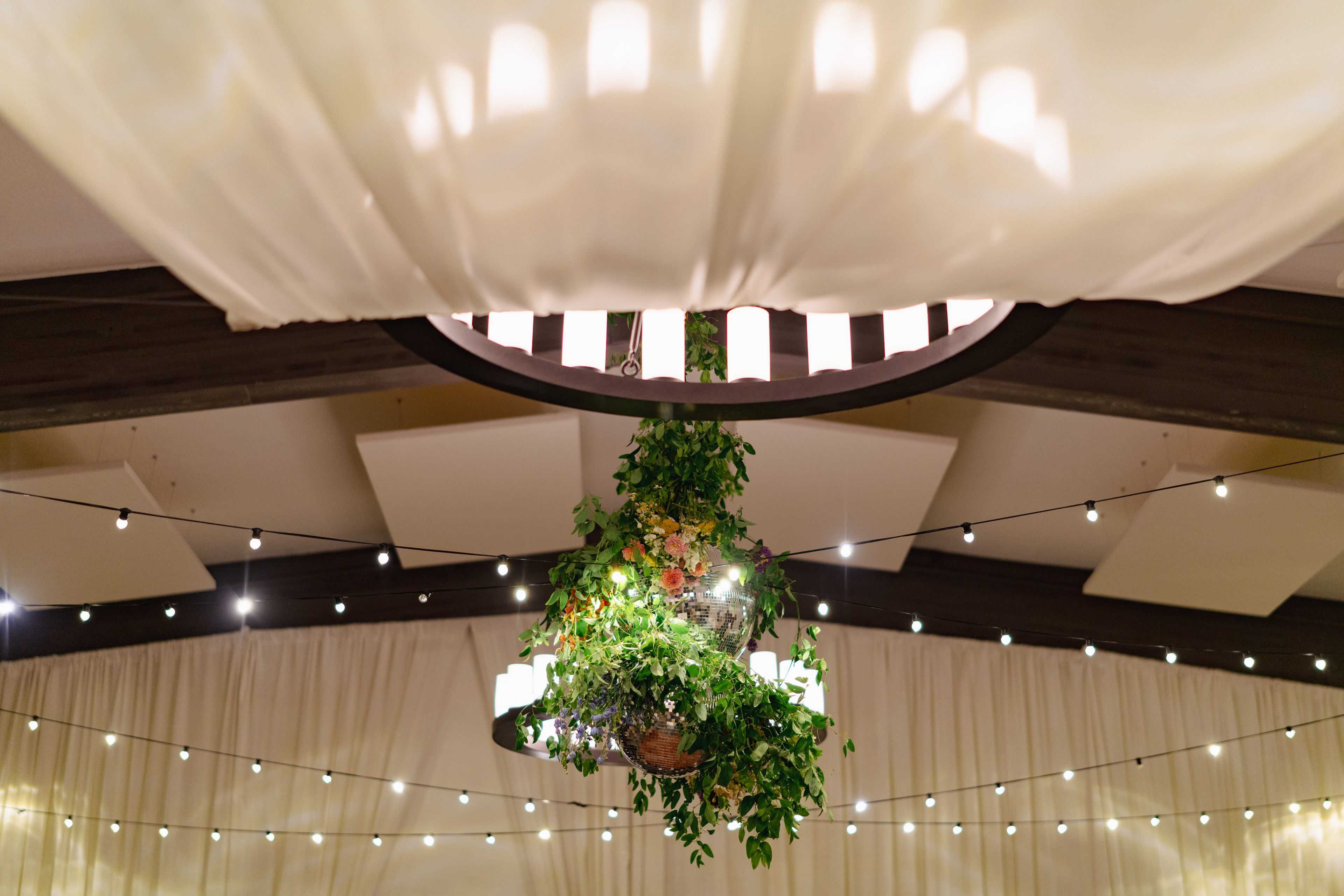 disco ball chandelier below drapery
