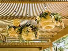 rattan lanterns with floral arrangements by Sierra lighting