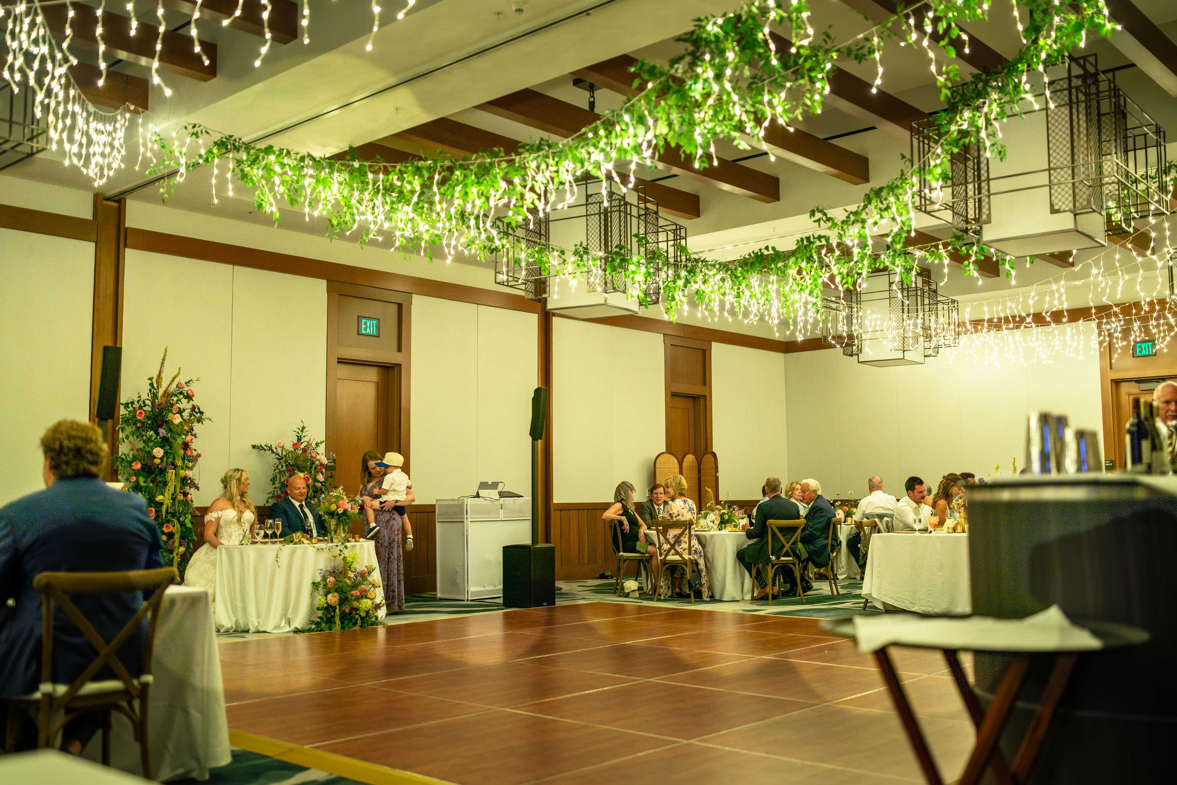 wedding reception with Sierra lighting hanging lighting over the ball room