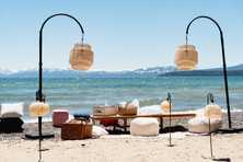 rattan lanterns hanging over a wedding scene on the shore of Lake Tahoe
