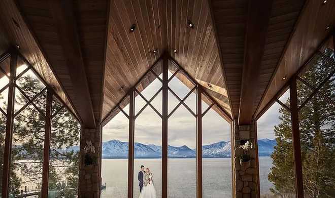 a wedding couple overlooks Lake Tahoe at the Edgewood resort in South Lake Tahoe