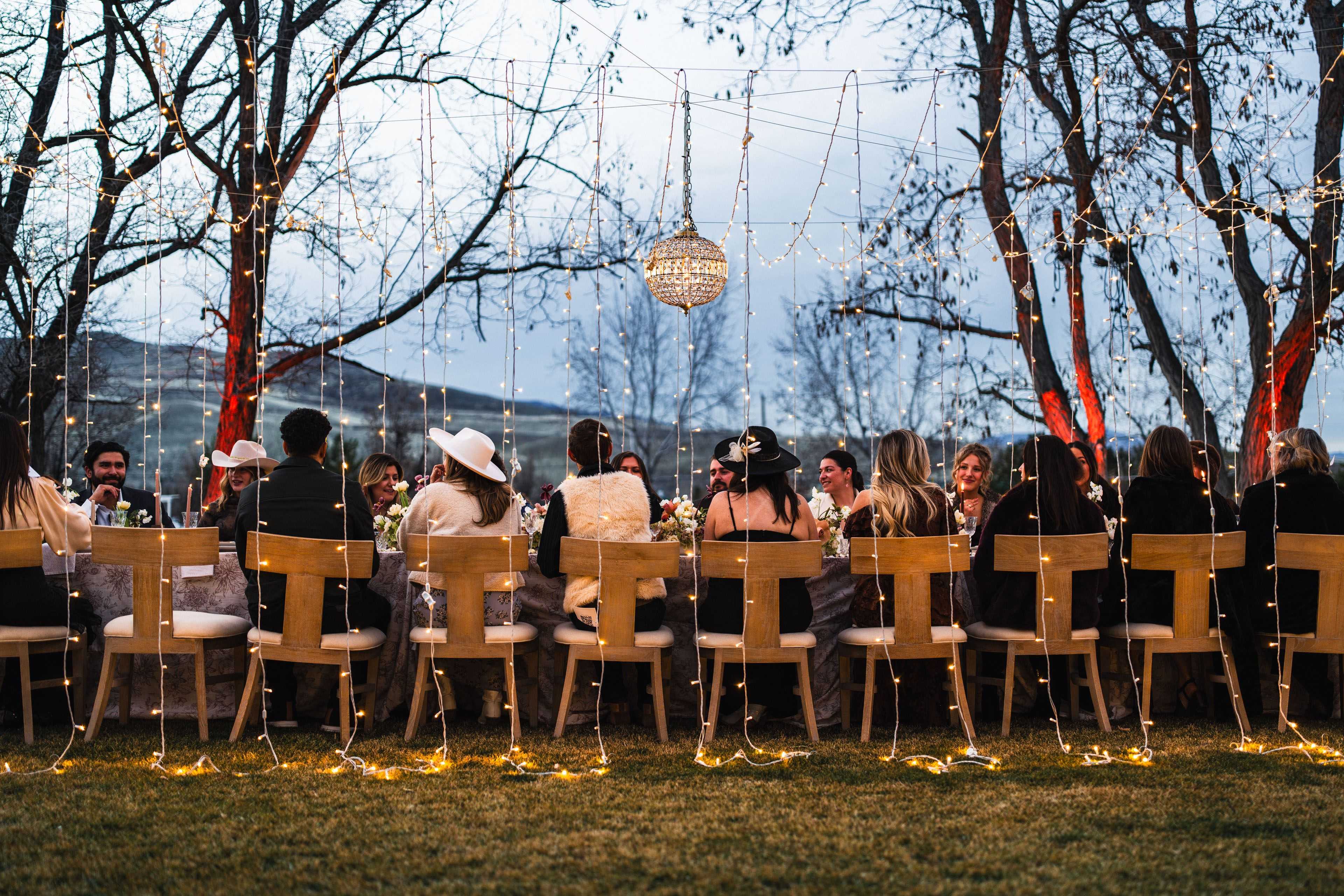 wedding table lit with chandelier and mini lights