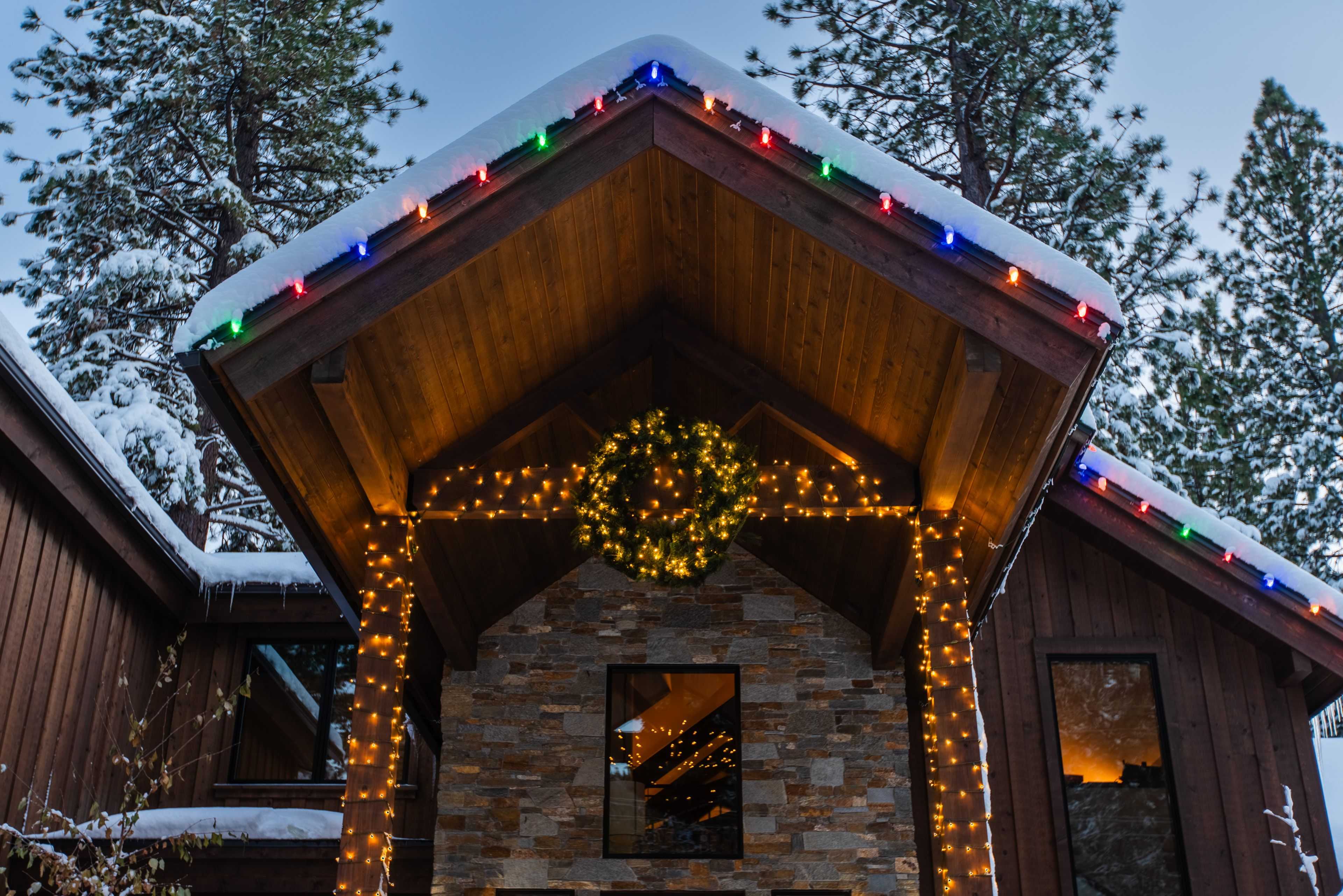 a Christmas wreath lit up in an entrance way