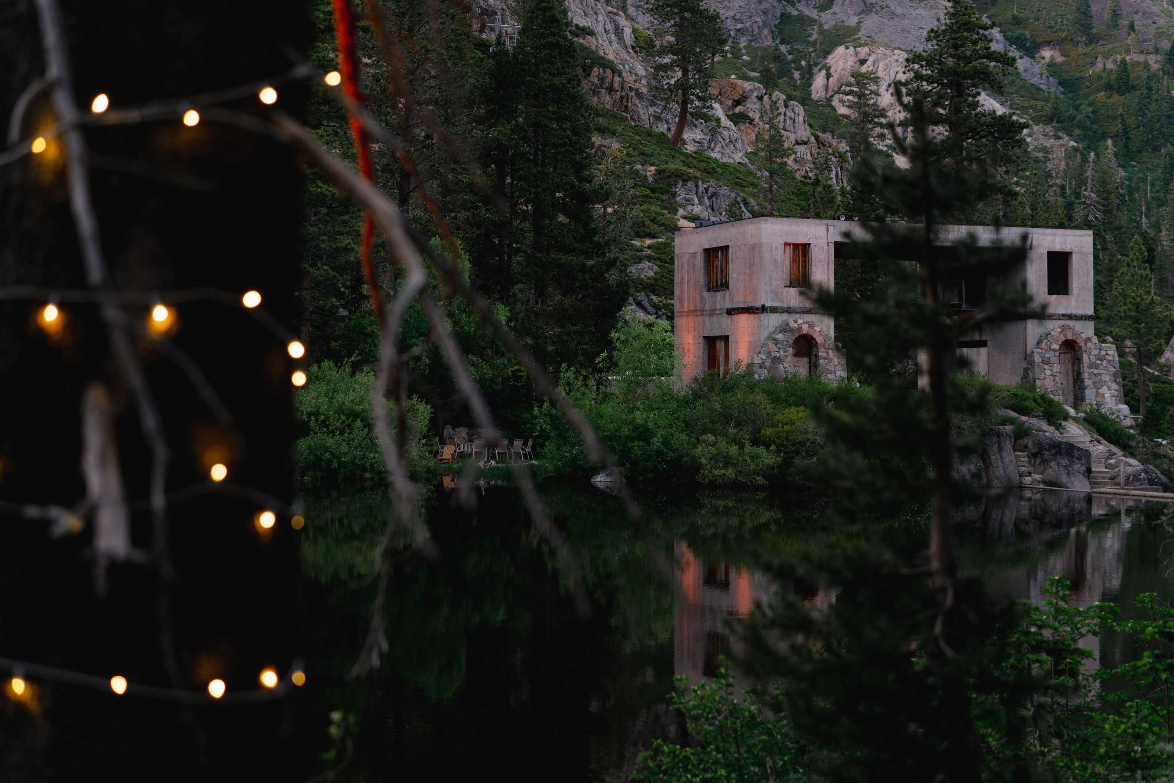 concrete building enhanced with colored uplighting over the lake at white wolf tahoe wedding venue