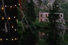 concrete building enhanced with colored uplighting over the lake at white wolf tahoe wedding venue