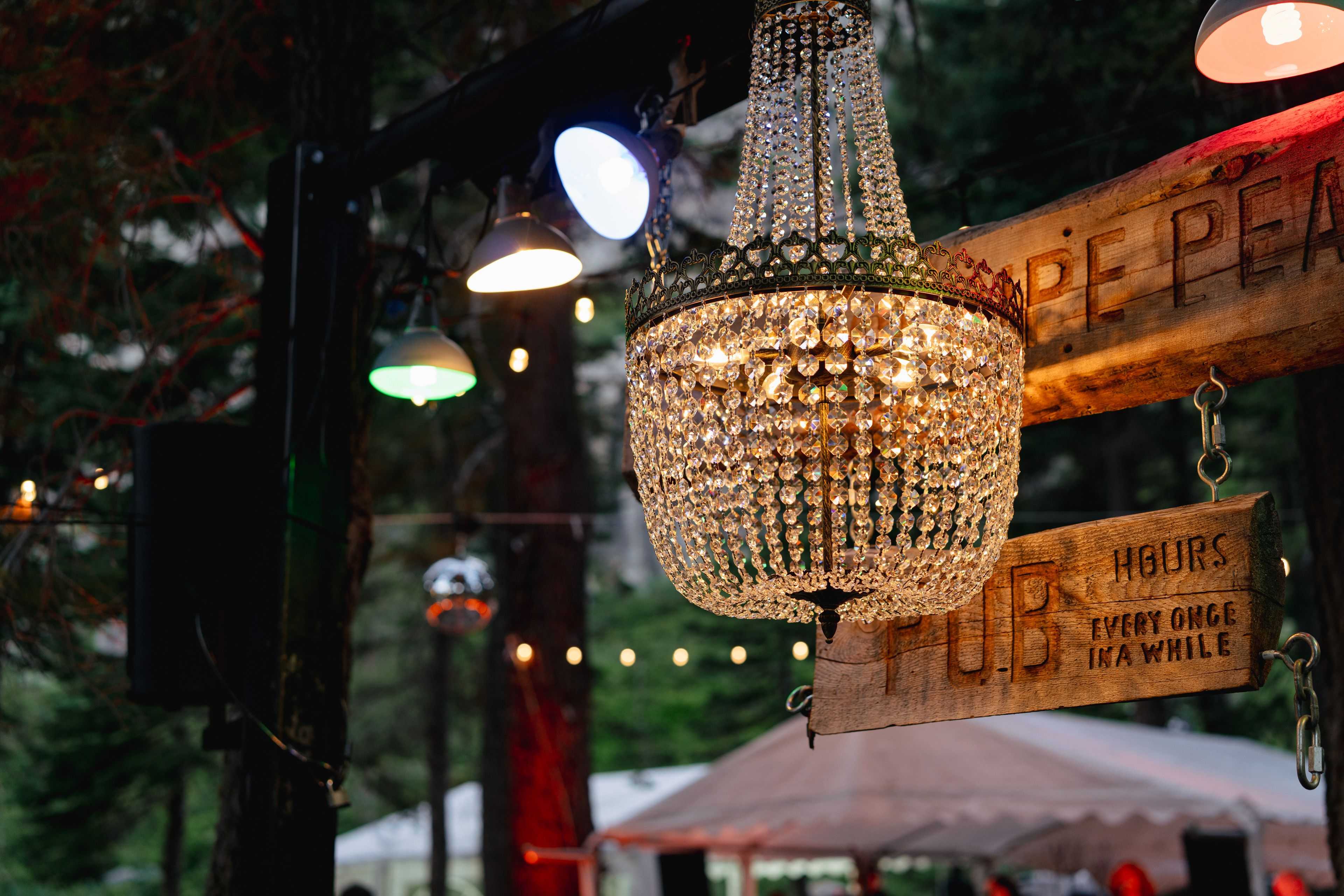 detail image of emporer chandelier above the rustic bar at white wolf wedding venue