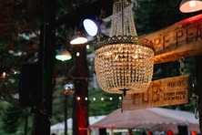 detail image of emporer chandelier above the rustic bar at white wolf wedding venue