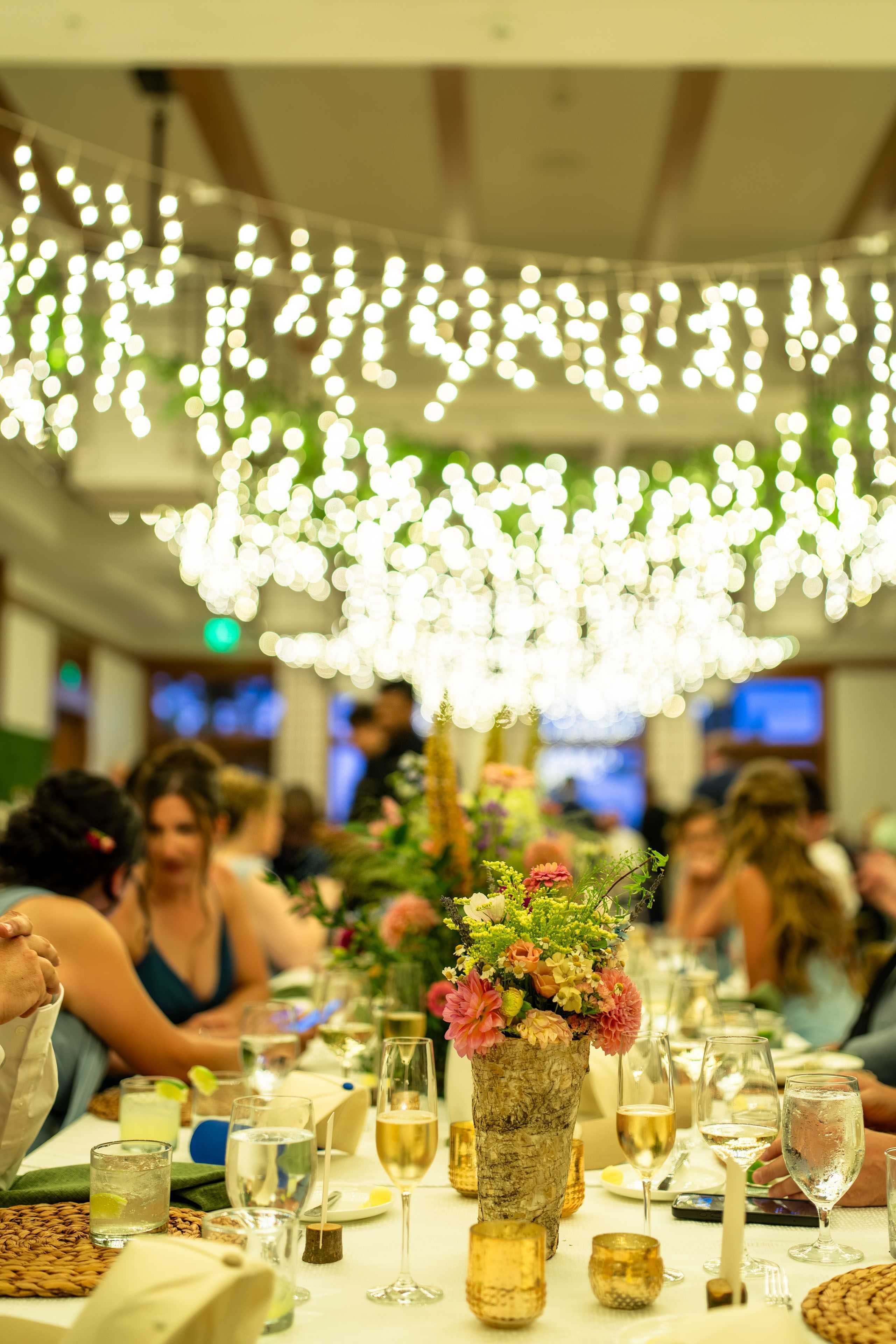 wedding reception with cute lighting over the flowers