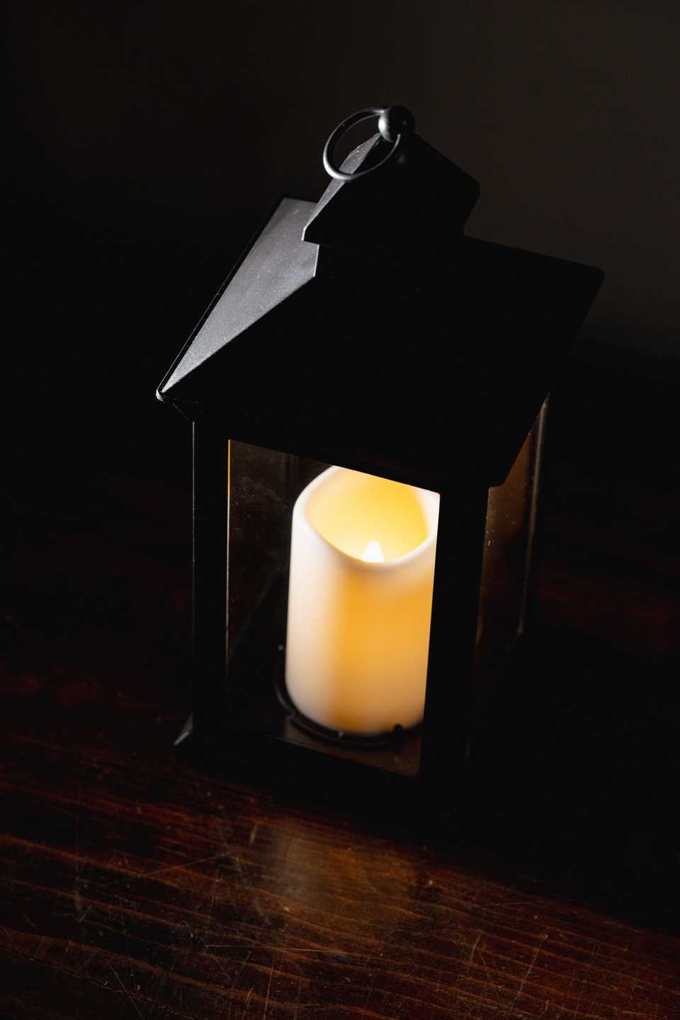 traditional lantern sitting on a wooden desk