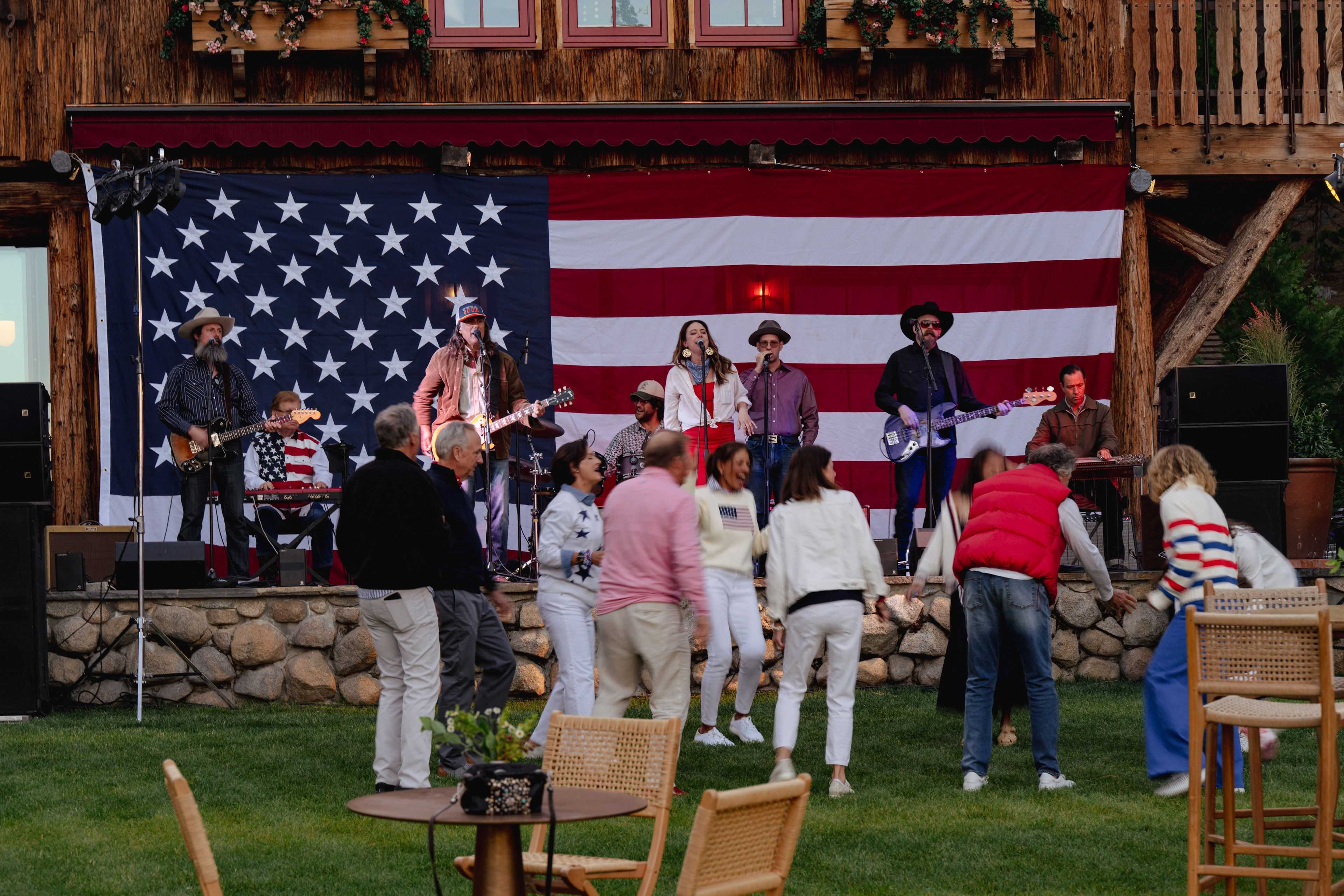 a live band playing in front of an American flag
