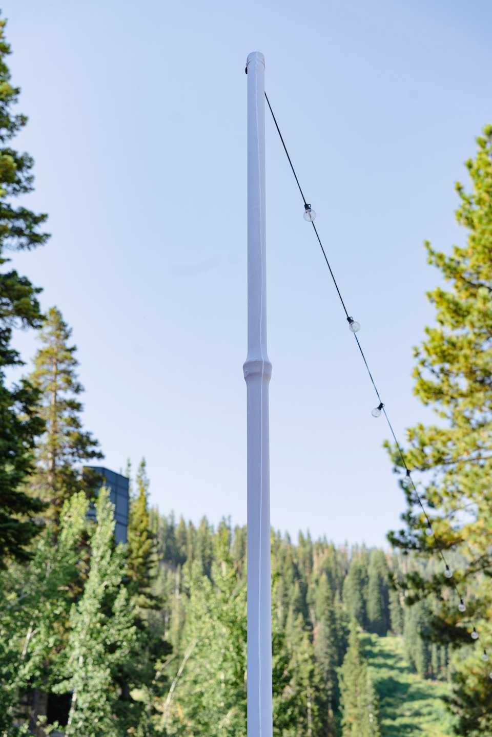 market light pole wrapped in white for wedding lighting