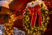 led lights on a Christmas wreath and wrapping a wooden beam