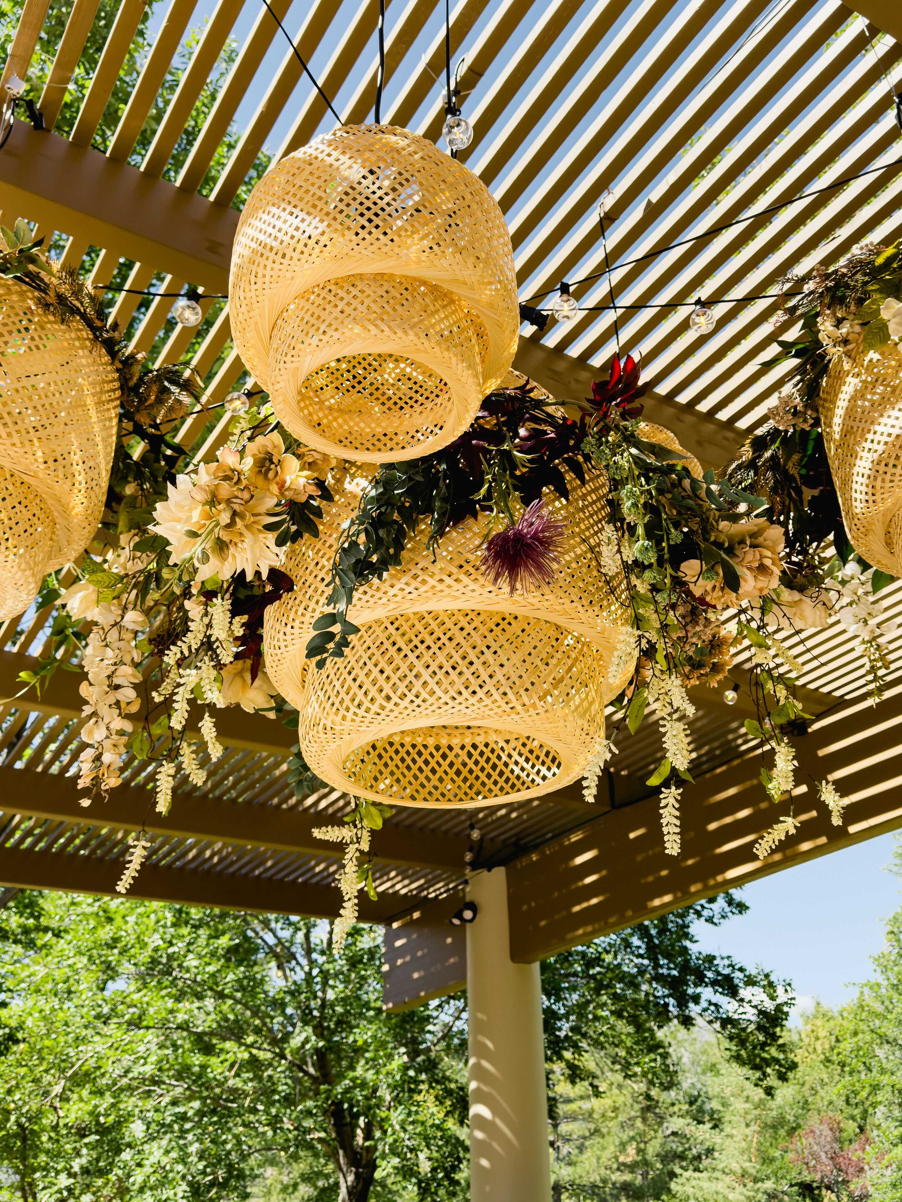 rattan lanterns under a pergola by Sierra lighting