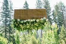 wedding flowers suspended above a wedding dance floor at an outdoor Lake Tahoe celcbration