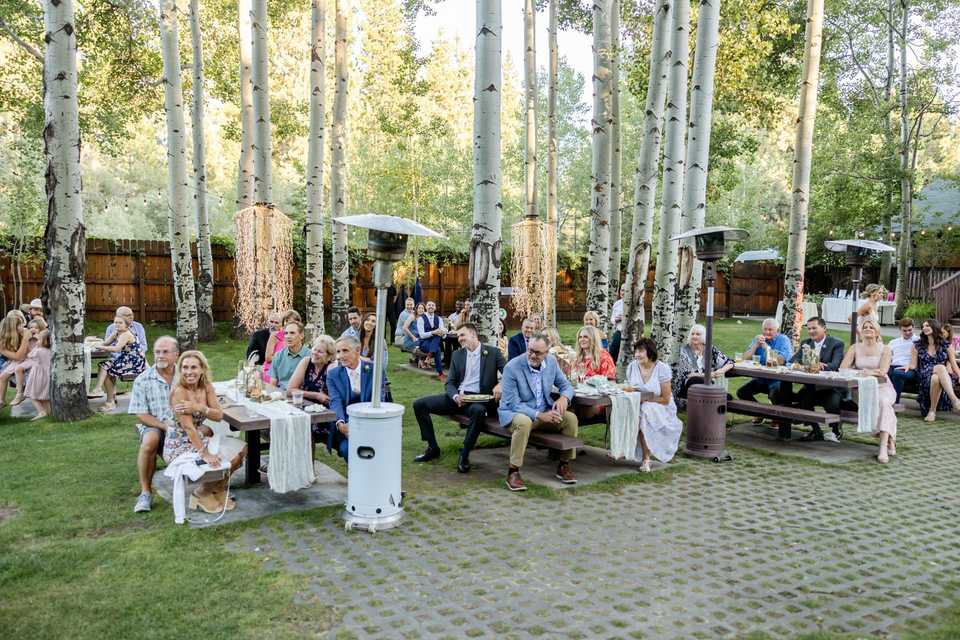 waterfall lighting behind a wedding in the trees of tahoe