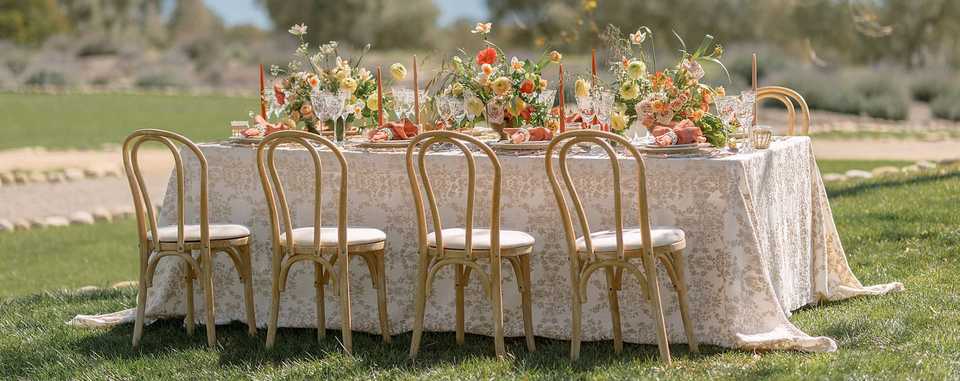outdoor wedding table styled with linen and floral