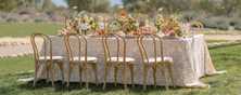 outdoor wedding table styled with linen and floral