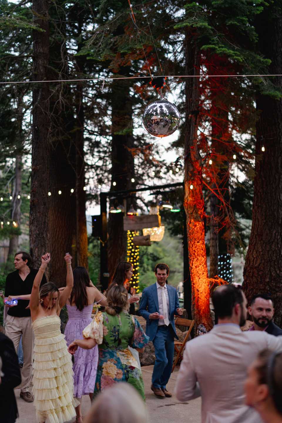 wedding guests dancing under a disco ball at an outside wedding venue in Tahoe