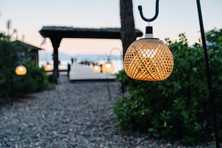 rattan lanterns guiding the pathway to a pier