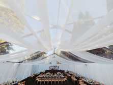 wedding drapery hanging from a clear tent