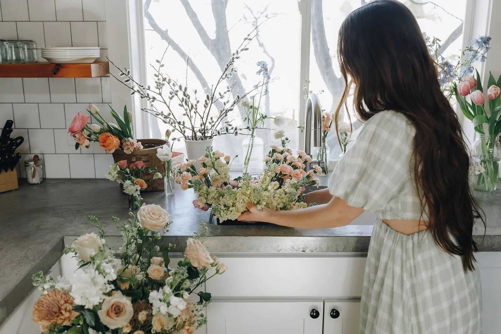 florist working on wedding a display in a kitchen