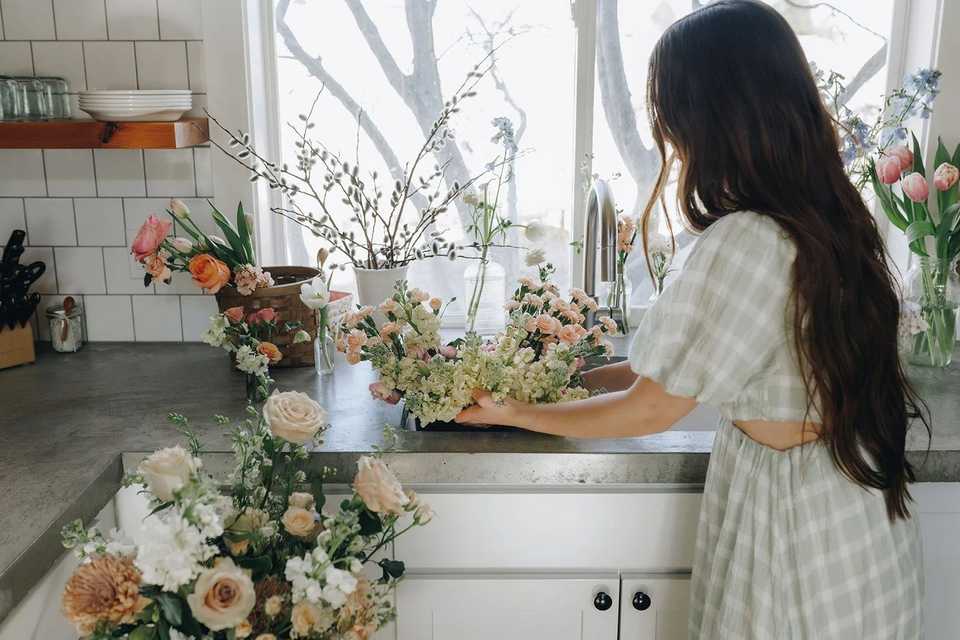 florist working on wedding a display in a kitchen